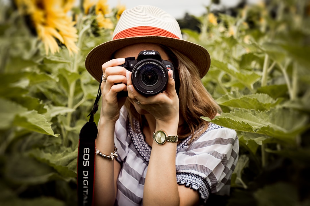 Photo by Andre Furtado woman taking photo of plants