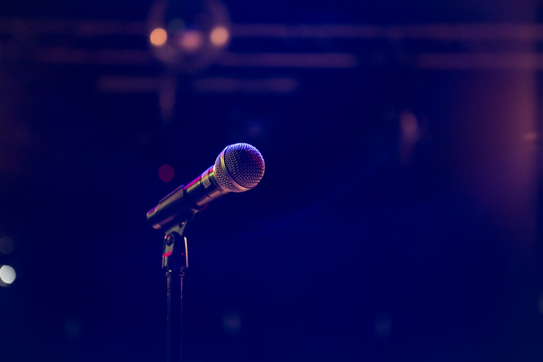 Photo by Matthias Wagner black and gray microphone on black stand